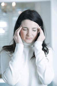 a woman suffering from headaches and migraine